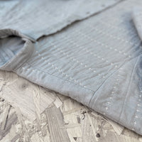 Recut Room Repurposed Hand Quilted Oyster Grey Linen Jacket with an all over hand quilted cross stitch in an off white embroidery thread